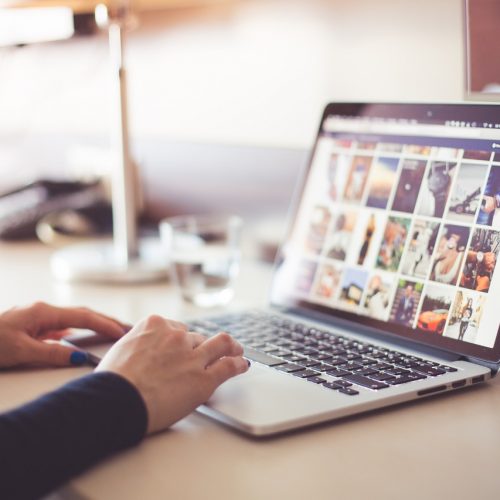 Woman on computer looking at images for seo mistakes