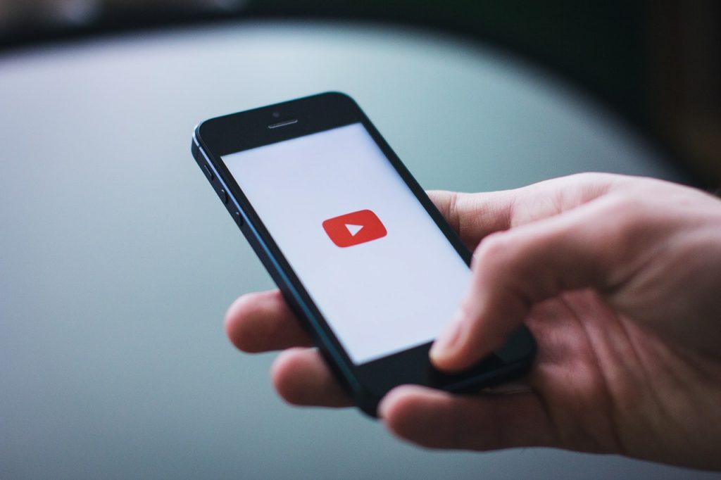 Person watching YouTube video marketing on their phone