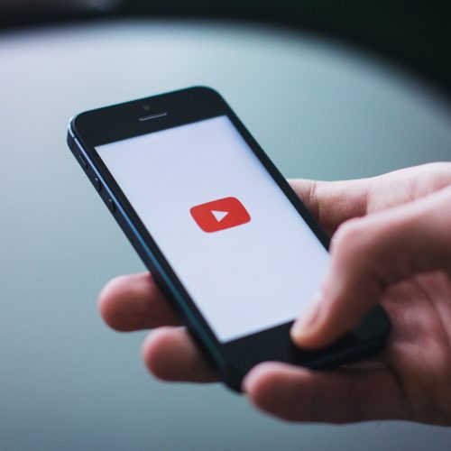 Person watching YouTube video marketing on their phone