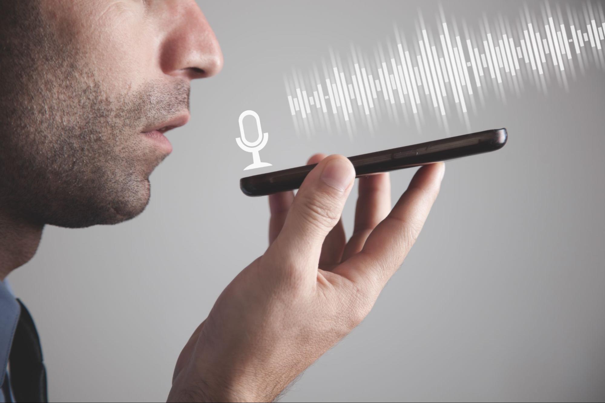 Man, searching for a dentist, speaks into a phone for a voice search.